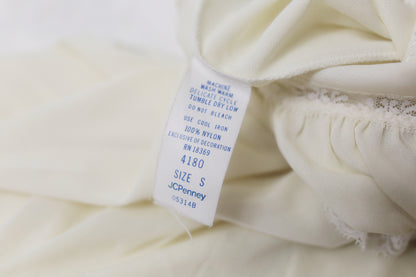 Close-up of a white garment with a tag displaying 'JCPenney' on a white background